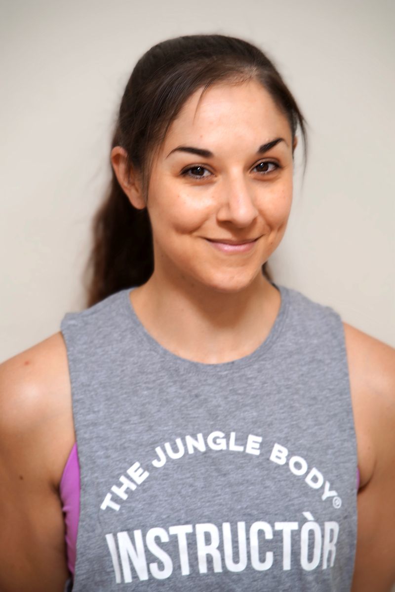 Nadia smiling in a Jungle Body instructor singlet